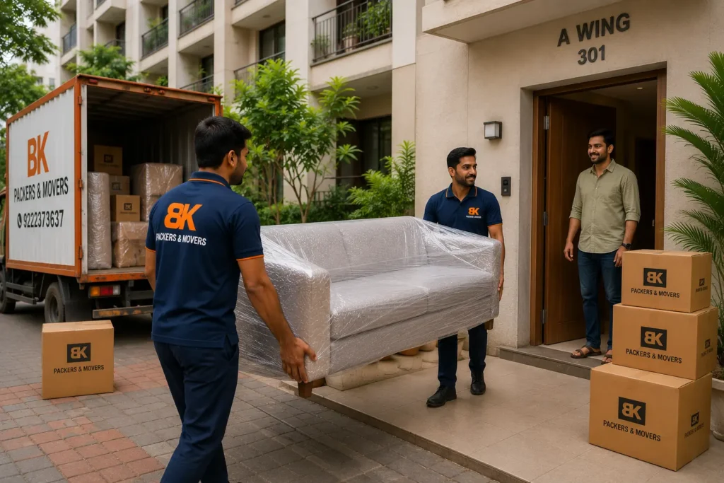 BK Packers and Movers team delivering wrapped furniture and household goods to a residential apartment in Ambernath