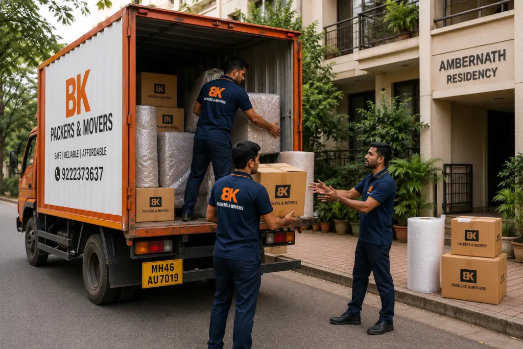BK Packers and Movers team loading household furniture, boxes, and packing materials into a moving truck in Ambernath